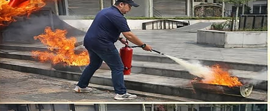 Fire safety drill — trainee using a fire extinguisher